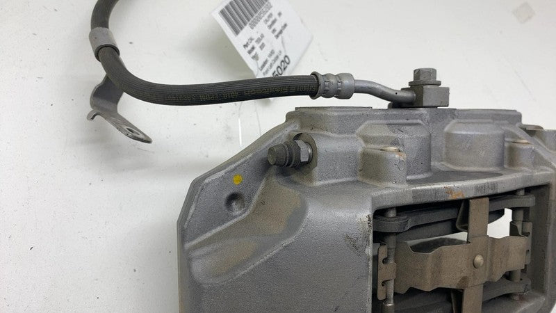 1044621-00-E 17-23 Model 3 Front Driver Side Caliper w/ Brake Hose Line Left LH 1044621-00-E