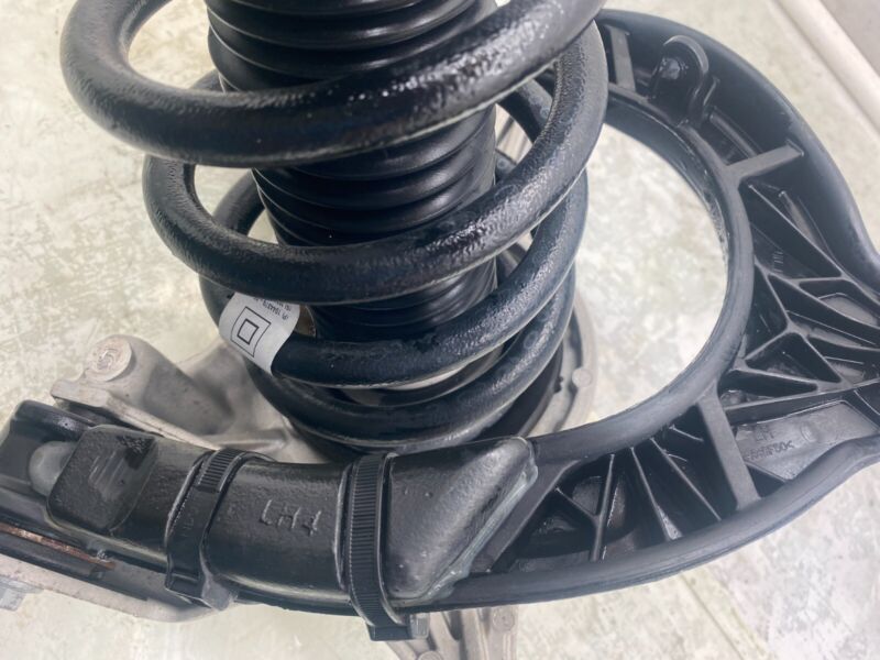 104409000A 17-20 Model 3 Left Shock Absorber w/ Control Arm Mid-Range Btry RWD 1044090-00-A